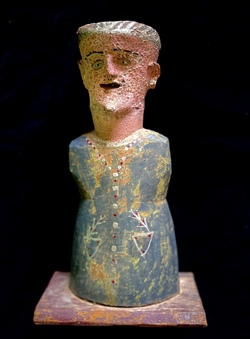 Figure in the form of a priest